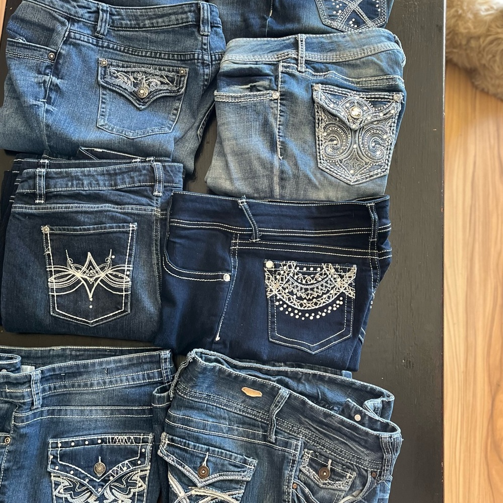 Women’s size 10 blue jeans,  some with bling, all like new without tags